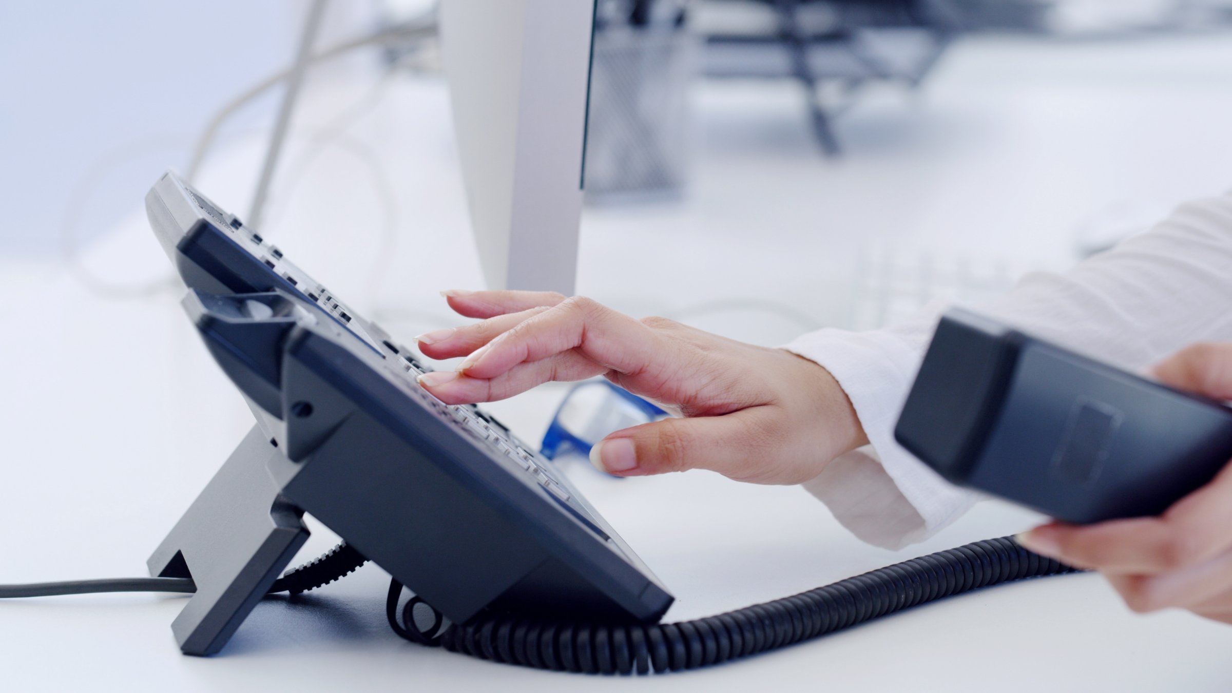 A customer service representative handles a phone call at a help desk. (Shutterstock Photo) 
