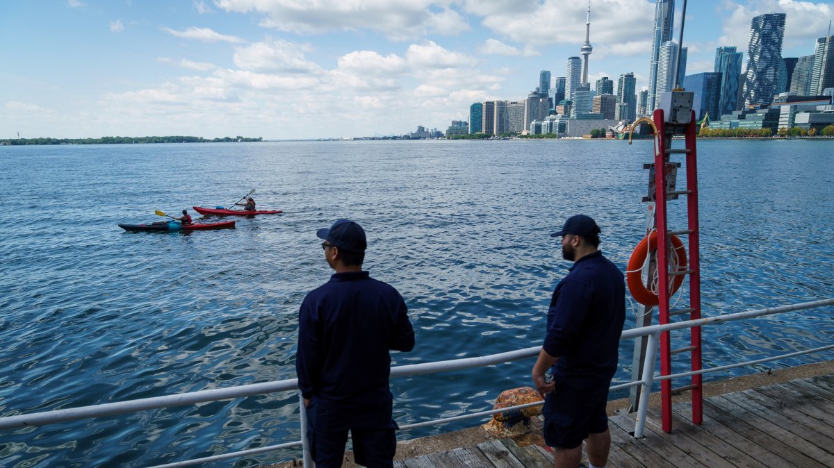 People look out across Lake Ontario and the Toronto Skyline from the Toronto Harbour in Toronto, Tuesday, Aug. 25, 2026. (AP Photo)