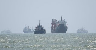 Vessels in the Strait of Hormuz are visible near the beach of Bandar Abbas, Iran, August 25, 2026. (Reuters Photo)