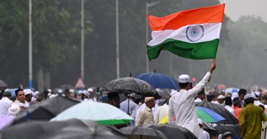 A Muslim devotee waves the national flag of India after the Eid al-Fitr prayer in Kolkata, India, March 21, 2026. (Getty Images Photo)