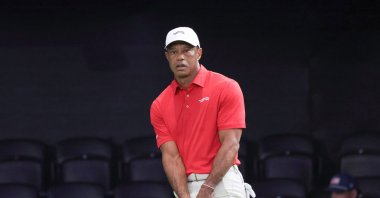 Tiger Woods of the Jupiter Links Golf Club makes a practice shot before the match, Palm Beach Gardens, March 24, 2026. (AP Photo)