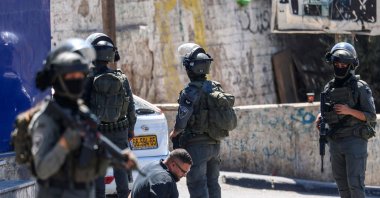 Israeli forces detain a Palestinian man during a raid on the UNRWA Vocational Training Centre, located between the Kafr Aqab neighbourhood and the Qalandia refugee camp, south of the West Bank city of Ramallah, Aug. 25, 2026. (AFP Photo)