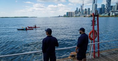 People look out across Lake Ontario and the Toronto Skyline from the Toronto Harbour in Toronto, Tuesday, Aug. 25, 2026. (AP Photo)