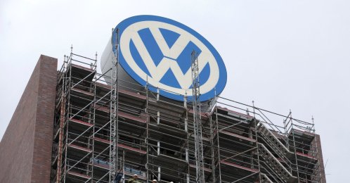 Employees stand on scaffolding below the Volkswagen logo on the roof of the company's headquarters, Wolfsburg, Germany, Sept. 22, 2015. (Reuters Photo)