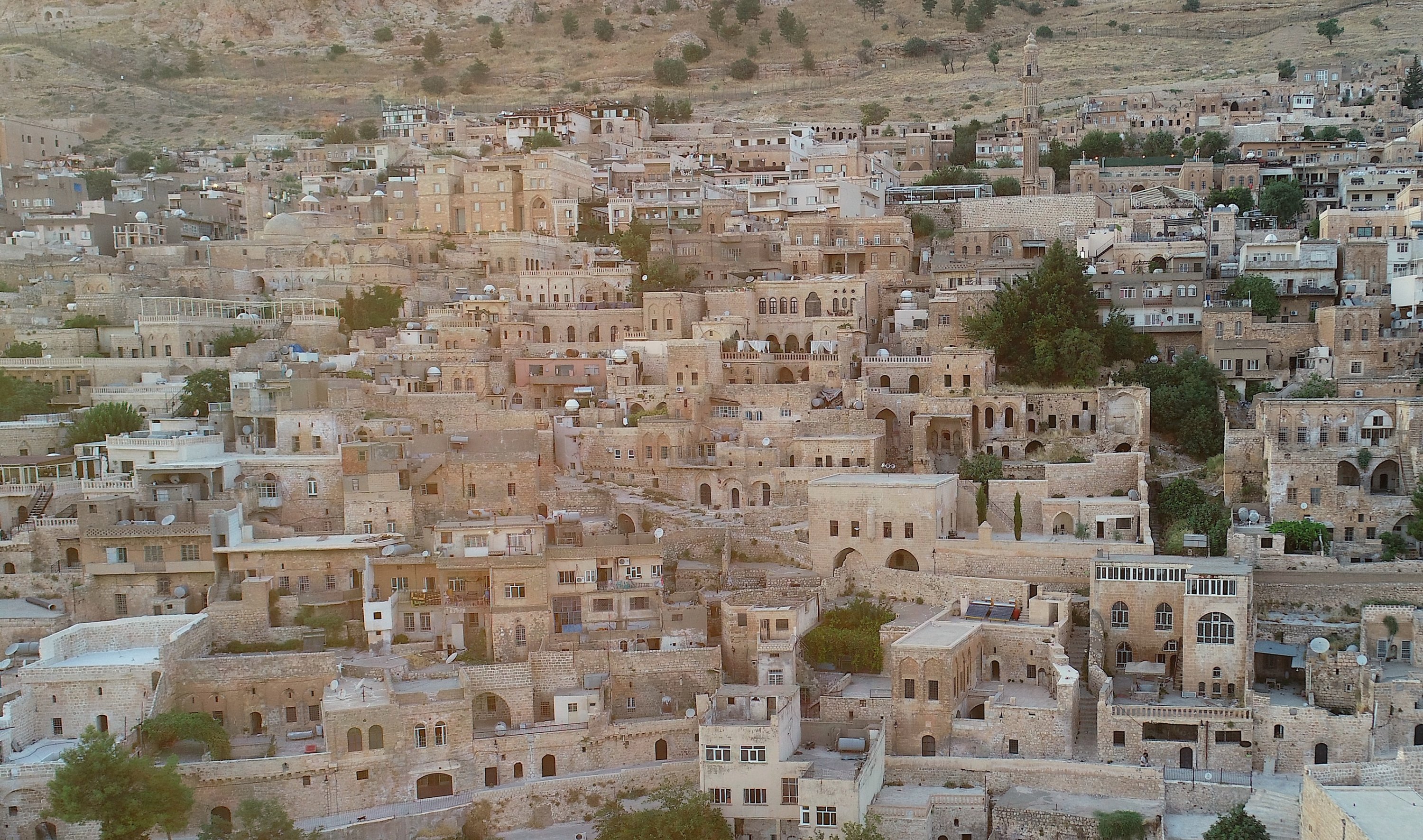 An aerial view of traditional stone houses and rooftop platforms used by residents to escape the summer heat, Mardin, southeastern Türkiye, Aug. 4, 2026. (AA Photo)