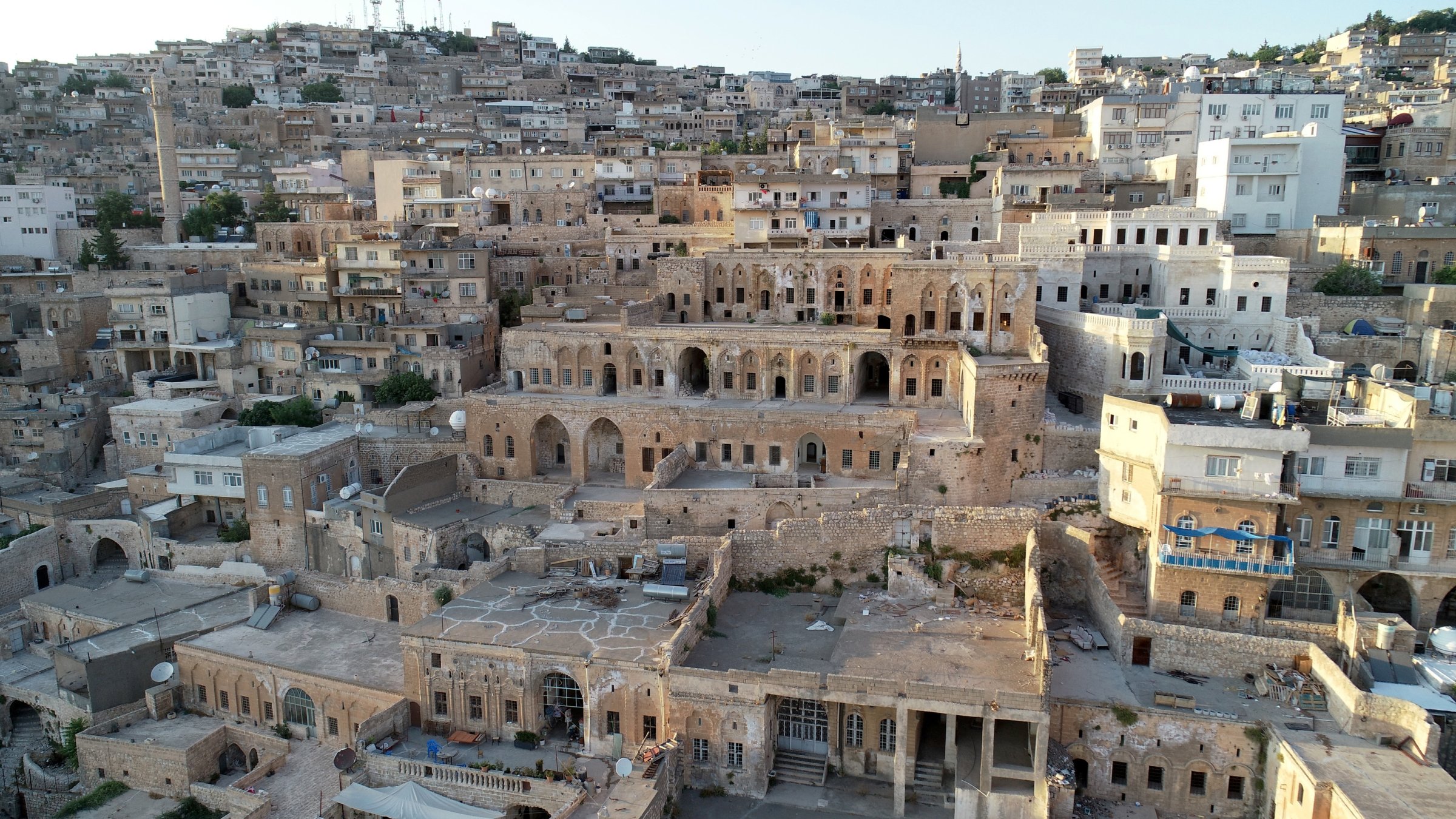 An aerial view of traditional stone houses and rooftop platforms used by residents to escape the summer heat, Mardin, southeastern Türkiye, Aug. 4, 2026. (AA Photo)