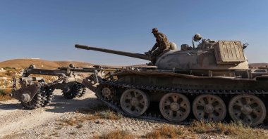 A Syrian army soldier sits on a mine-clearing tank of the Syrian Ministry of Defence's military engineering department during a demining operation, Qarah, Syria, Aug. 23, 2026. (AFP Photo)