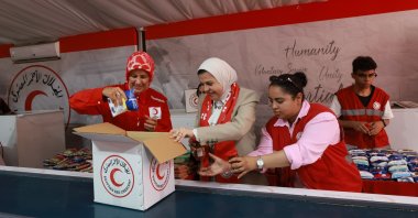 Turkish Red Crescent President Fatma Meriç Yılmaz and a delegation pack aid supplies for Gaza, Rafah, Egypt, Aug. 25, 2026. (AA Photo)