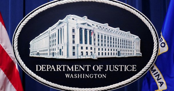A U.S. Justice Department logo or seal showing Justice Department headquarters, known as "Main Justice," is seen behind the podium in the Department's headquarters briefing room before a news conference with the Attorney General in Washington, Jan. 24, 2023. (Reuters File Photo)