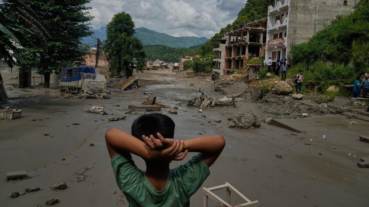 A boy looks at the devastation caused by flash flooding along the Trishuli River in Nuwakot district, Nepal, Aug. 26, 2026. (AP Photo)