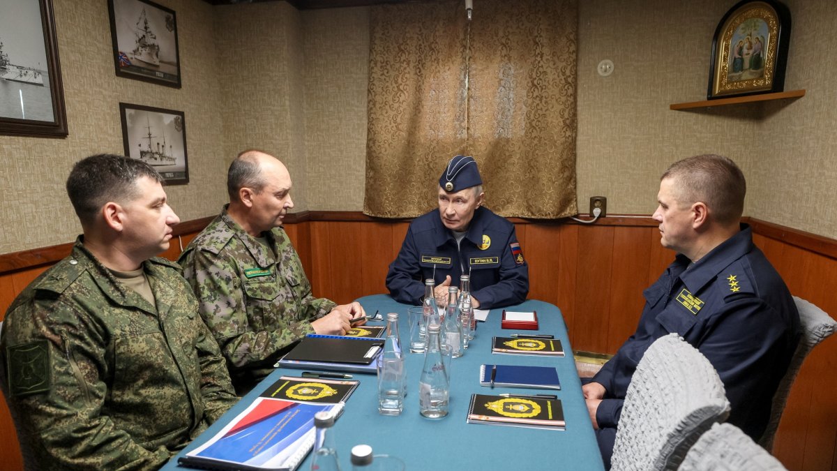 Russian President Vladimir Putin chairs a meeting on board the missile cruiser "Varyag” as he observes a military drill of the Pacific fleet, in Russia's far eastern Sakhalin Region, Russia, Aug. 13, 2026. (Reuters Photo)