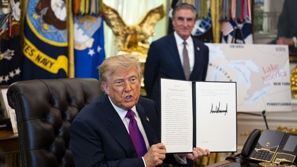 U.S. President Donald Trump shows a signed executive order to rename Lake Ontario as Lake America, amid a recent trade war, in the Oval Office of the White House in Washington, D.C., Aug. 2026. (EPA Photo)