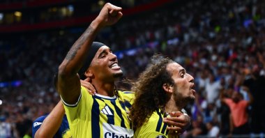 Fenerbahçe's Matteo Guendouzi (R) and Archie Brown celebrate after beating Olympique Lyon in the UEFA Champions League playoffs, Lyon, France, Aug. 27, 2028. (AA Photo)