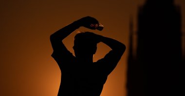 A person holds a plastic bottle at sunset amid a heat wave in Frankfurt am Main, Germany, July 30, 2026. (EPA Photo)