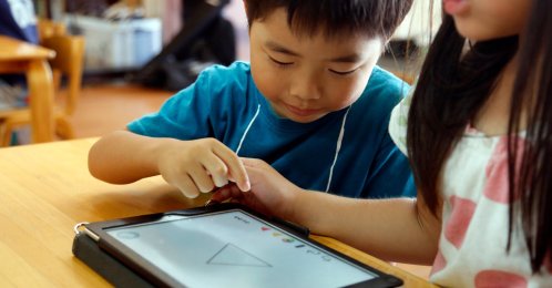 Children work on a digital program at Coby Preschool in Yoshikawa, Tokyo, Japan, July 12, 2018. (AP Photo)