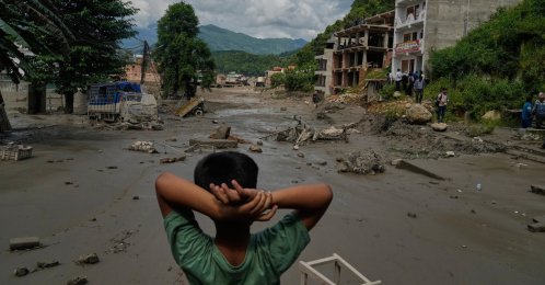 A boy looks at the devastation caused by flash flooding along the Trishuli River in Nuwakot district, Nepal, Aug. 26, 2026. (AP Photo)