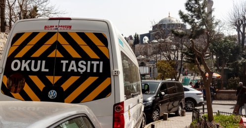 A white school bus with a “School Bus” sign, Istanbul, Türkiye, March 24, 2022. (Shutterstcok Photo) 