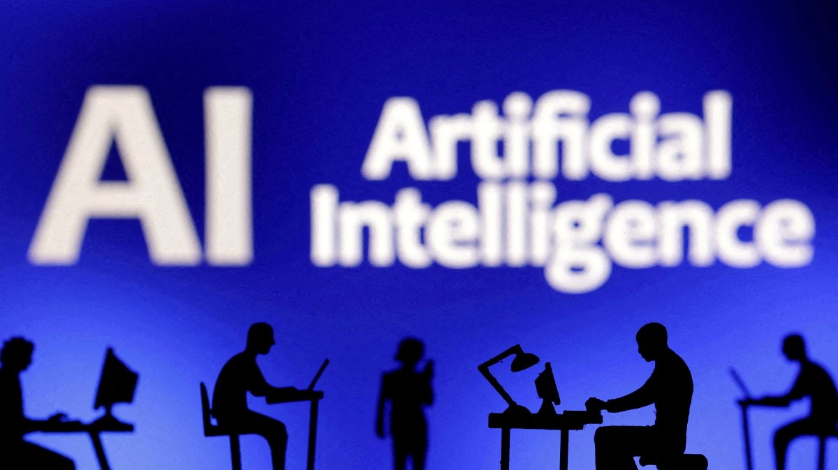 Figurines with computers and smartphones seen in front of the words "Artificial Intelligence AI" in this illustration taken, Feb. 19, 2024. (Reuters Photo)