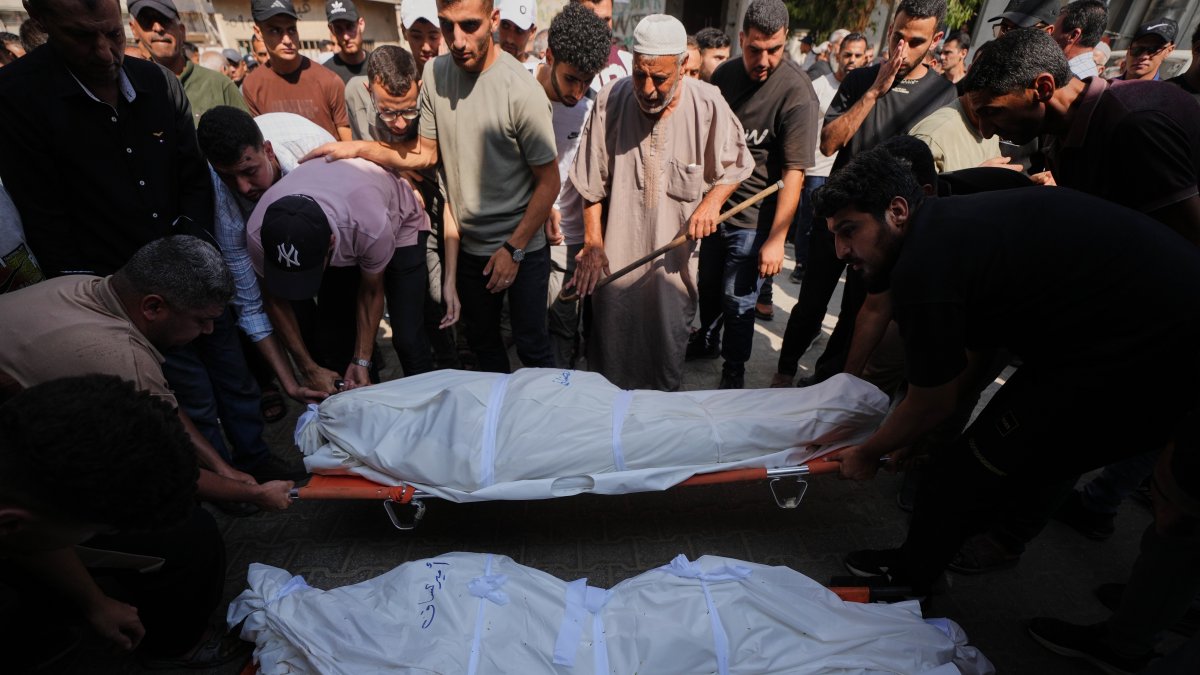 Palestinians mourn over the bodies of their relatives killed in an Israeli army strike during their funeral at Shifa Hospital, Gaza City, Palestine, Aug. 26, 2026. (AP Photo)