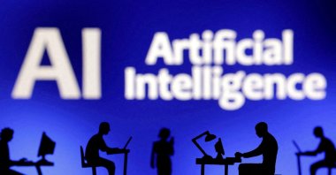 Figurines with computers and smartphones seen in front of the words "Artificial Intelligence AI" in this illustration taken, Feb. 19, 2024. (Reuters Photo)