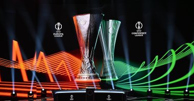 The UEFA Europa League and UEFA Conference League trophies are displayed on stage ahead of the draws for the two competitions at the Grimaldi Forum, Monaco, Aug. 28, 2026. (AA Photo)