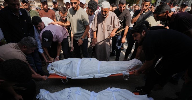 Palestinians mourn over the bodies of their relatives killed in an Israeli army strike during their funeral at Shifa Hospital, Gaza City, Palestine, Aug. 26, 2026. (AP Photo)