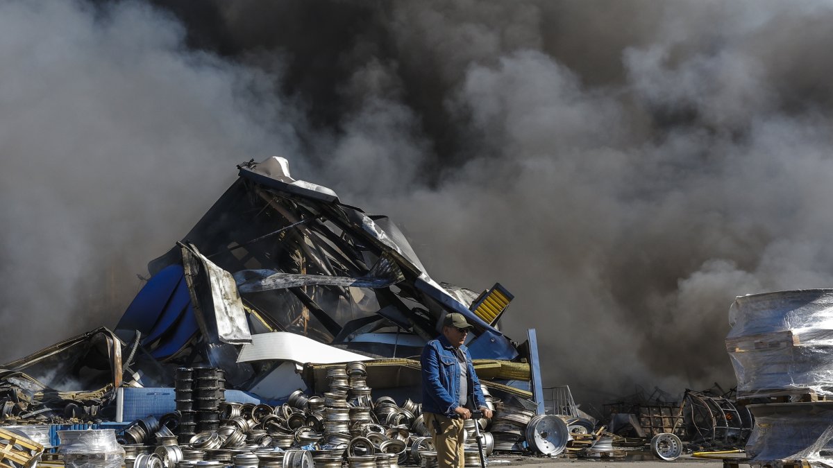 A man rides a scooter at the site of a Russian strike on a goods storage facility amid the Russian invasion, Kyiv, Ukraine, Aug. 29, 2026. (EPA Photo)