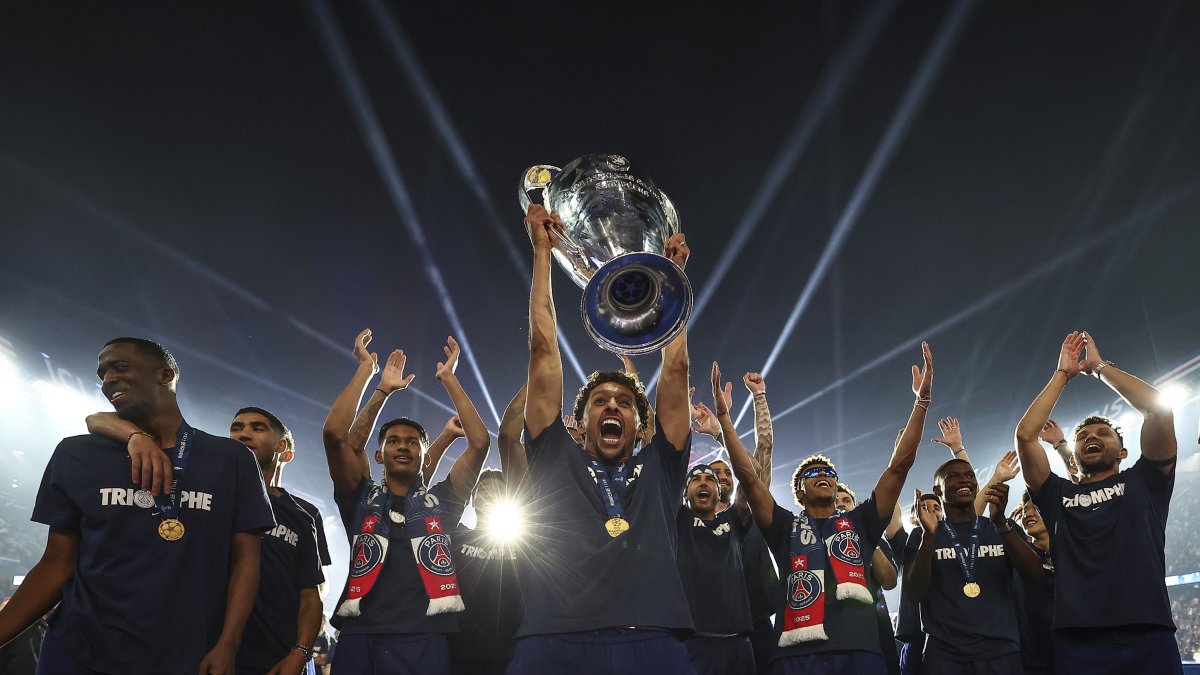 Paris Saint-Germain's captain Marquinhos, holding the cup, celebrates with teammates during a ceremony to present the trophy a day after Paris Saint-Germain (PSG) won the UEFA Champions League, at the Parc des Princes Stadium, Paris, France, June 1, 2025. (AP Photo)
