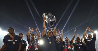 Paris Saint-Germain's captain Marquinhos, holding the cup, celebrates with teammates during a ceremony to present the trophy a day after Paris Saint-Germain (PSG) won the UEFA Champions League, at the Parc des Princes Stadium, Paris, France, June 1, 2025. (AP Photo)