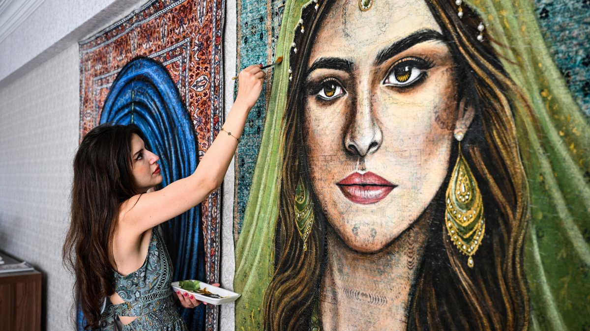 Computer engineer and artist Gizem Aytaç paints a portrait on a carpet, Elazığ, eastern Türkiye, Aug. 27, 2026. (AA Photo)