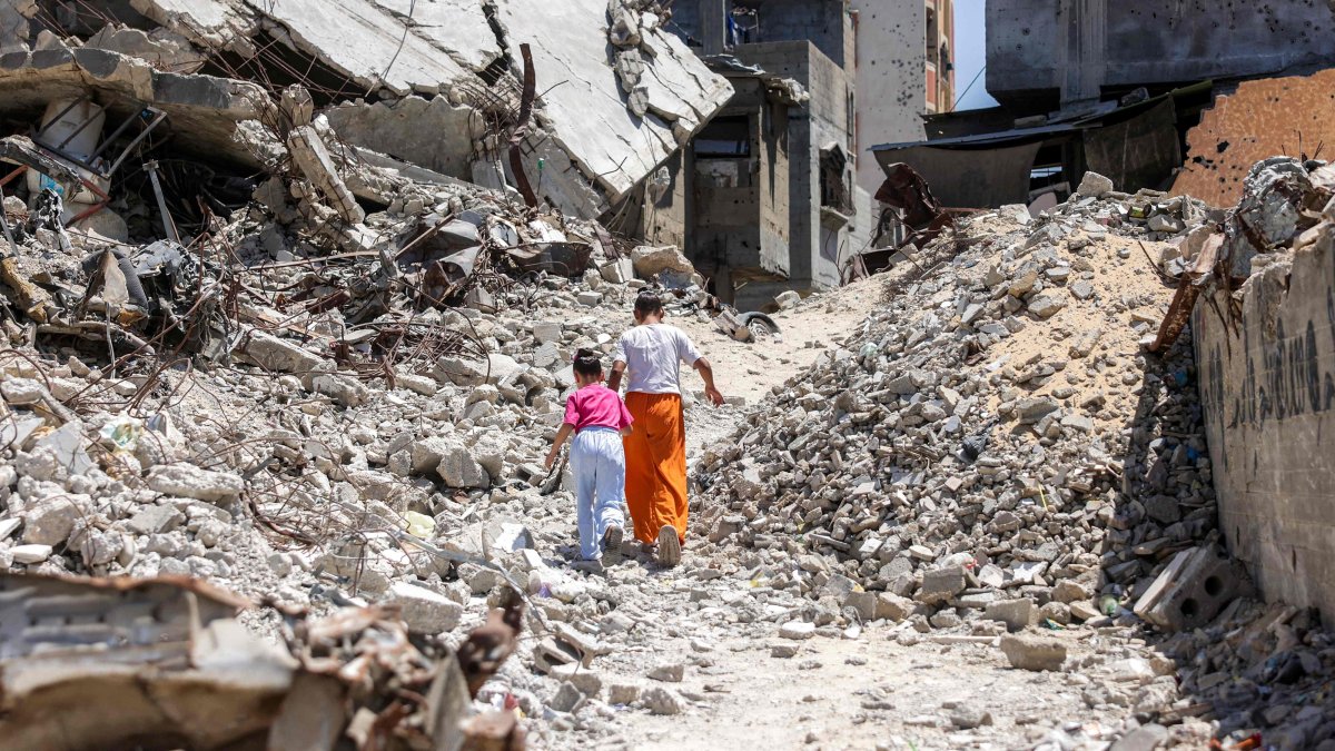 Two girls walk past the rubble of buildings destroyed in Israeli attacks in Khan Younis, southern Gaza Strip, Palestine, Aug. 25, 2026. (AFP Photo)