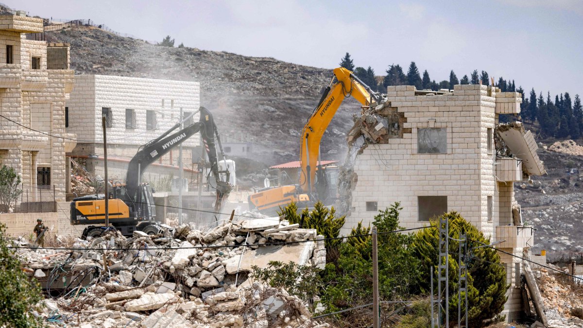 Israeli army excavators demolish Palestinian buildings on the outskirts of Nablus in the Israeli-occupied West Bank, Aug. 31, 2026. (AFP Photo)