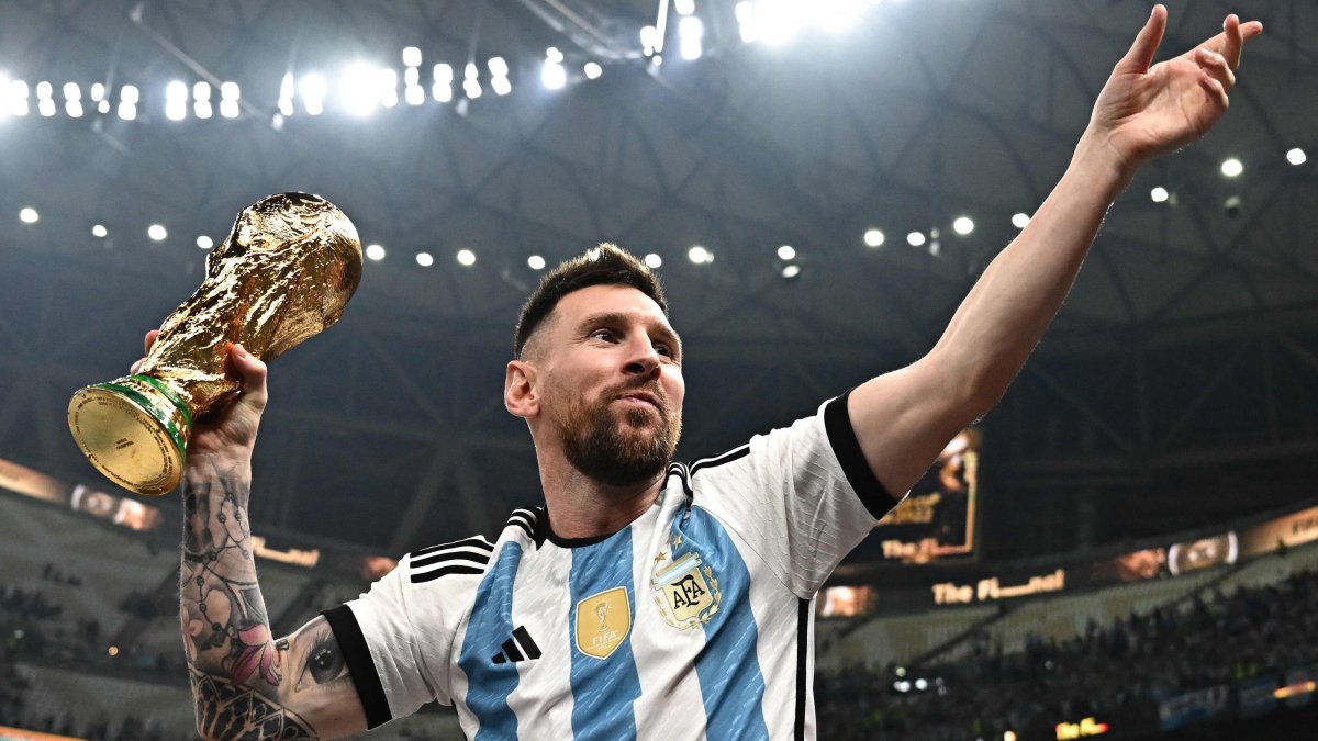 Argentina's captain Lionel Messi poses with the FIFA World Cup Trophy after Argentina won the Qatar 2022 World Cup final football match between Argentina and France at Lusail Stadium in Lusail, north of Doha, Qatar, Dec. 18, 2022. (AFP Photo)