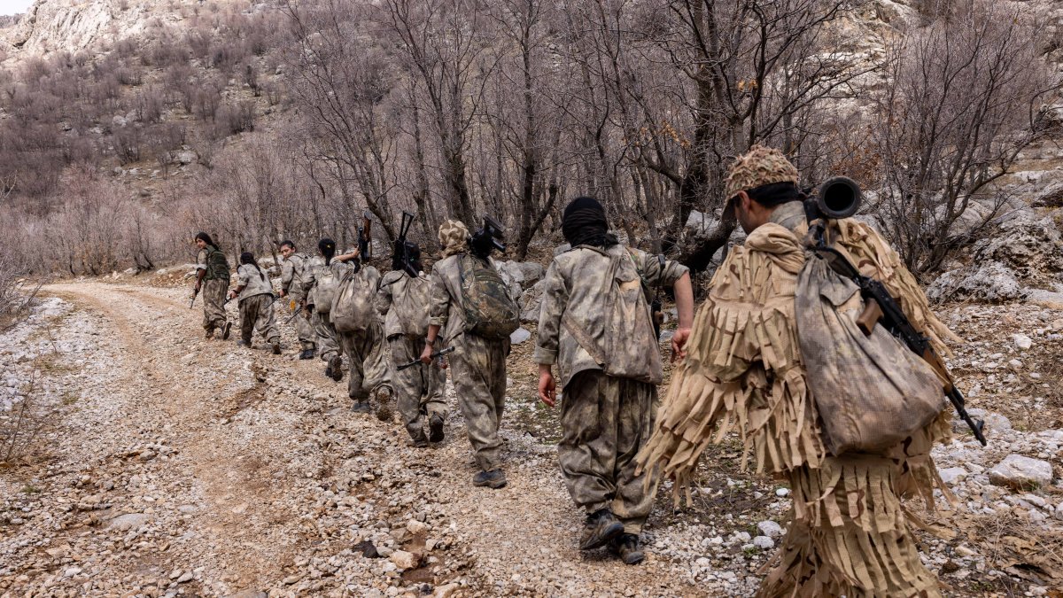 PJAK terrorists are seen walking near a mountain at an unidentified location in Iran, in this undated file photo. (Photo by Afshin Ismaeli / NTB via AFP)
