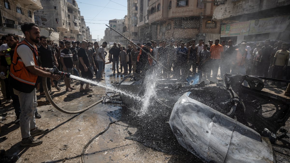 Palestinians inspect a destroyed car following an Israeli air strike on Gaza City, Palestine, Aug. 31, 2026. (EPA Photo)