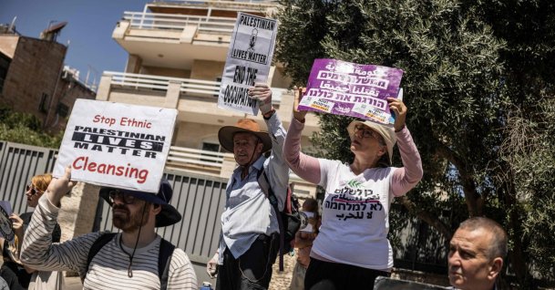 Israeli activists hold up posters as they demonstrate, calling for an end to settler violence, outside the European Union office in Jerusalem, Aug. 28, 2026. (AFP Photo)