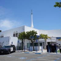 People gather as police vehicles are parked outside of the Islamic Center of San Diego, the day after a shooting, in San Diego, U.S., May 19, 2026. (AP Photo)