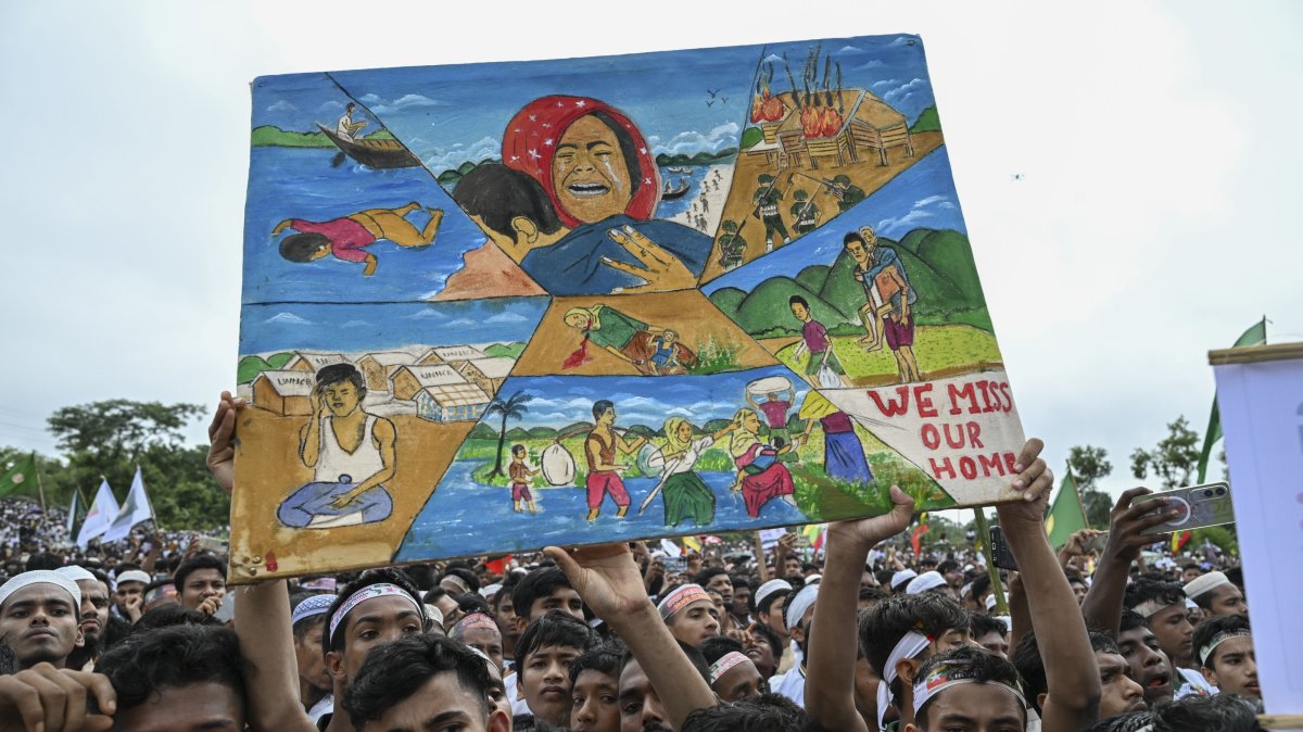 Rohingya refugees hold paintings during the Genocide Remembrance Day rally to mark the anniversary of their mass expulsion from Myanmar by the military, at a refugee camp, Cox's Bazar, Bangladesh, Aug. 25, 2026. (AA Photo)
