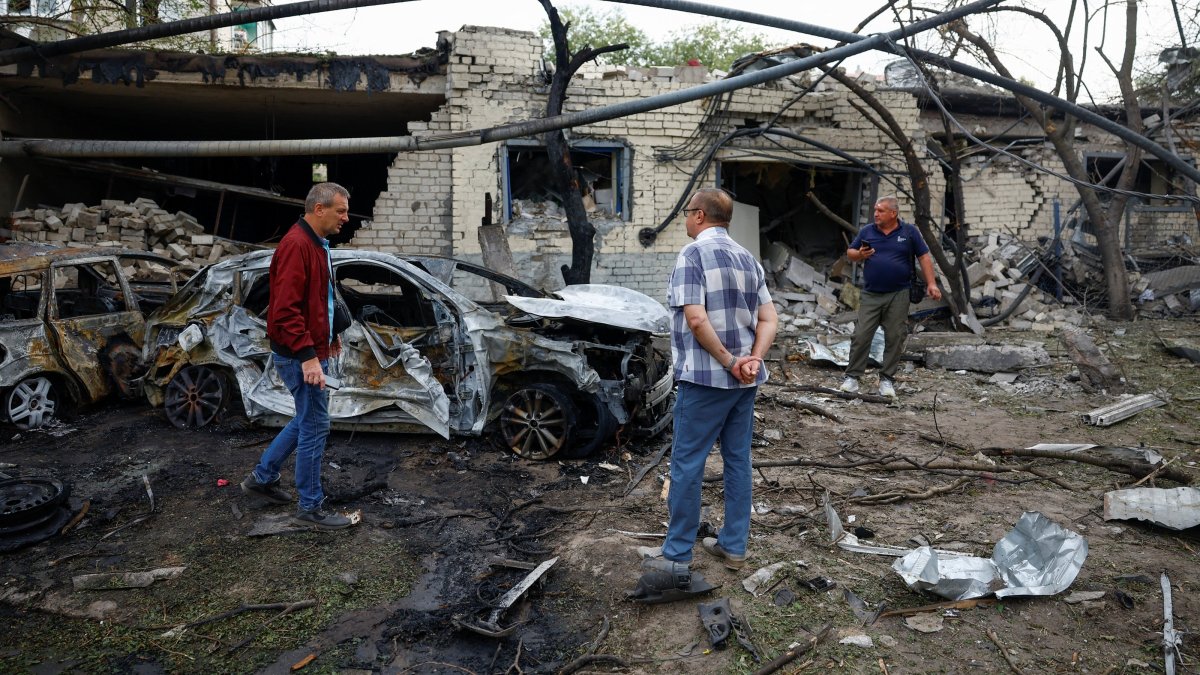 Residents stand near cars burned after a Russian missile strike in the town of Boryspil, amid Russia's attack on Ukraine, in Kyiv region, Ukraine, Sept. 1, 2026. (Reuters Photo)