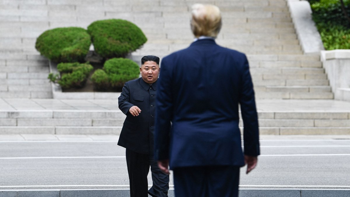North Korea's leader Kim Jong Un walks to greet U.S. President Donald Trump at the Military Demarcation Line that divides North and South Korea, June 30, 2019. (AFP Photo)