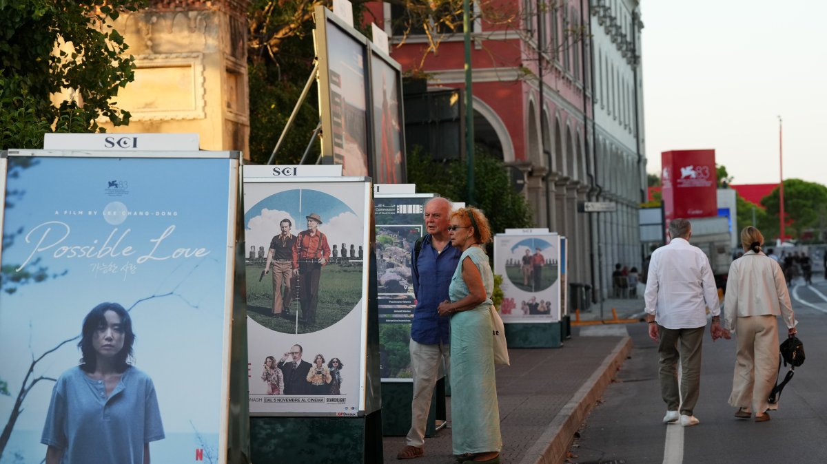 People view film posters prior to the 83rd edition of the Venice Film Festival, Venice, Italy, Aug. 31, 2026. (AP Photo)