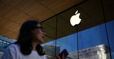 A woman walks past an Apple store, Beijing, China, Aug. 31, 2026. (AFP Photo)
