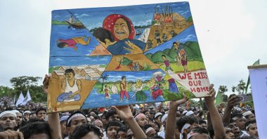 Rohingya refugees hold paintings during the Genocide Remembrance Day rally to mark the anniversary of their mass expulsion from Myanmar by the military, at a refugee camp, Cox's Bazar, Bangladesh, Aug. 25, 2026. (AA Photo)
