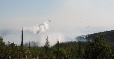 Firefighting aircraft conduct aerial operations as crews battle a forest fire, Çanakkale, Türkiye, Aug. 31, 2026. (AA Photo)