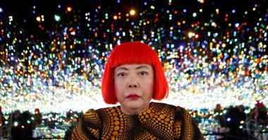 Japanese artist Yayoi Kusama poses for a photograph inside her Infinity Mirrored Room installation titled "The Souls of Millions of Light Years Away" during a media preview of her new exhibition at the David Zwirner gallery, New York, U.S., Nov. 7, 2013. (Reuters Photo)