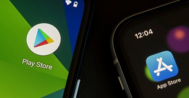 Google Play Store and Apple App Store icons are seen on phone displays, Portland, U.S., April 21, 2021. (Shutterstock Photo)