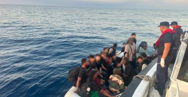 Irregular migrants, including children, are seen after being intercepted in two separate operations by security forces, Izmir, Türkiye, Aug. 25, 2026. (IHA Photo)