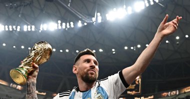Argentina's Lionel Messi poses with the FIFA World Cup Trophy after Argentina won the Qatar 2022 World Cup final football match against France at Lusail Stadium, Lusail, Qatar, Dec. 18, 2022. (AFP Photo)