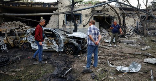 Residents stand near cars burned after a Russian missile strike in the town of Boryspil, in Kyiv region, Ukraine, Sept. 1, 2026. (Reuters Photo)