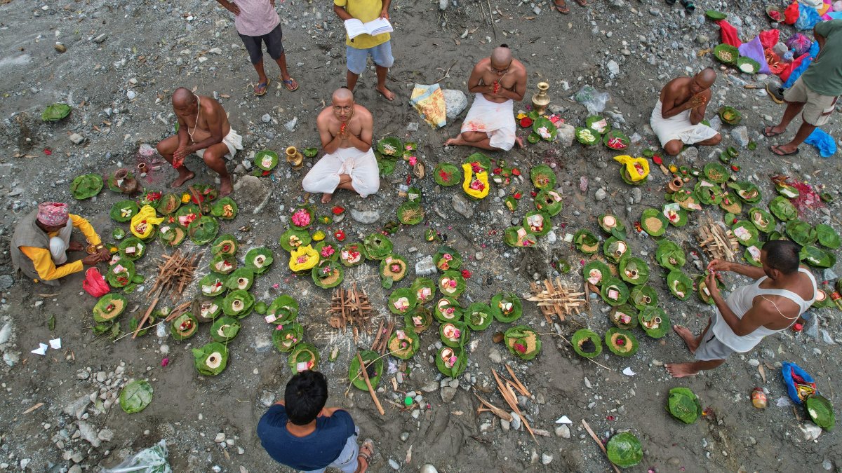 People whose relatives remain missing following flash floods perform rituals after symbolic funeral rites on the banks of the swollen Trishuli River, Nuwakot, Nepal, Sept. 2, 2026. (AP Photo)